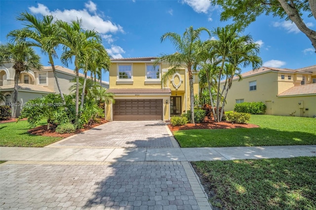 9003 Alexandra Cir, Wellington, FL 33414 - mediterranean / spanish home featuring a tiled roof, a front lawn, decorative driveway, stucco siding, and an attached garage