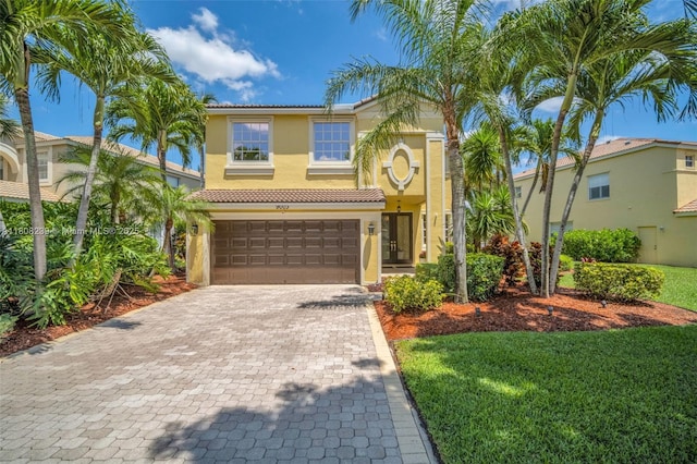 9003 Alexandra Cir, Wellington, FL 33414 - view of front of home featuring stucco siding, a garage, a tile roof, decorative driveway, and a front yard