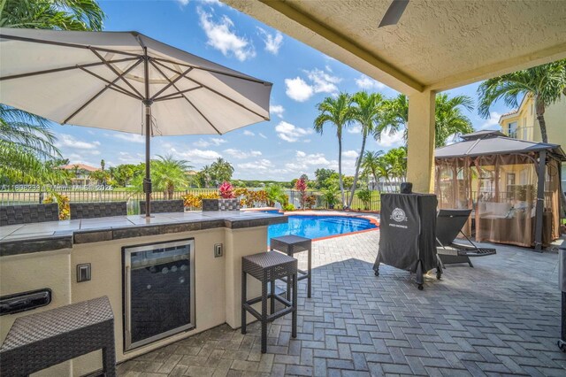 9003 Alexandra Cir, Wellington, FL 33414 - fenced backyard featuring a patio, an outdoor bar, and area for grilling