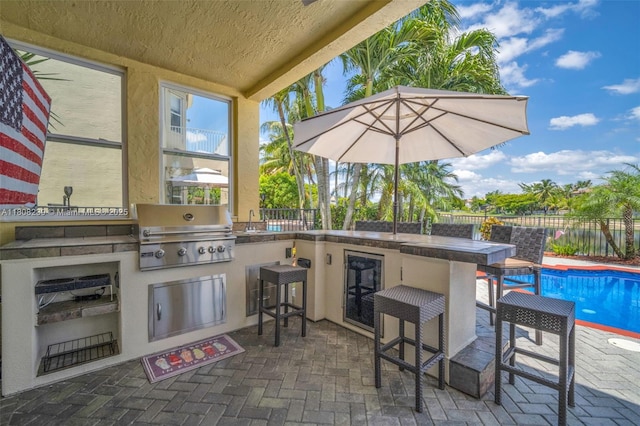 9003 Alexandra Cir, Wellington, FL 33414 - view of patio / terrace with exterior kitchen and wine cooler
