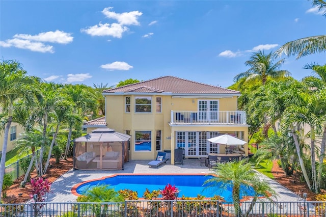 9003 Alexandra Cir, Wellington, FL 33414 - back of property featuring a balcony, a gazebo, french doors, a fenced backyard, and stucco siding