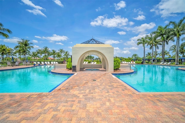 9003 Alexandra Cir, Wellington, FL 33414 - community pool featuring a patio and a community hot tub