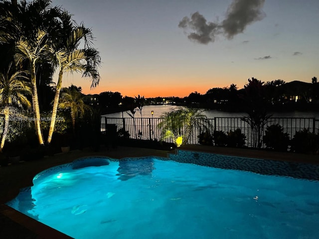 9003 Alexandra Cir, Wellington, FL 33414 - pool at dusk featuring a water view
