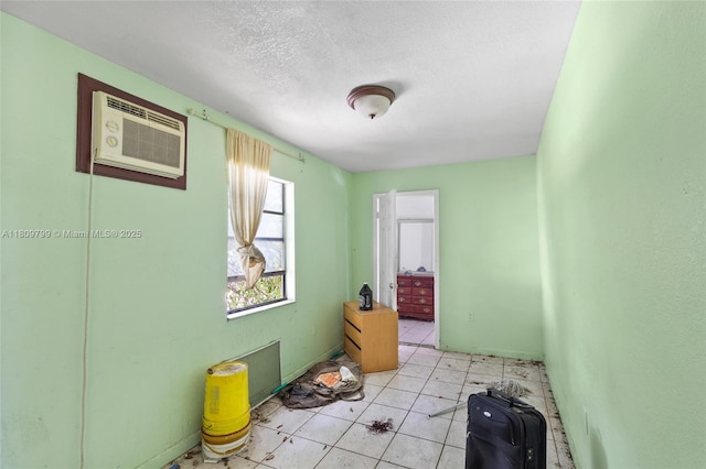 226 NW 16th Ave, Miami, FL 33125 - spare room featuring an AC wall unit, a textured ceiling, and light tile patterned floors