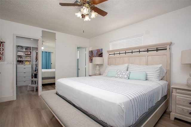 5920 SW 94th Ave, Miami, FL 33173 - bedroom with wood finished floors, a spacious closet, a closet, a ceiling fan, and a textured ceiling