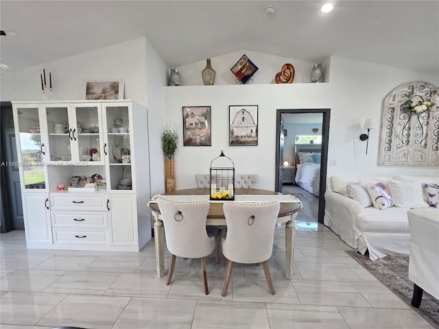7935 NW 90th Ct, Okeechobee, FL 34972 - dining area featuring vaulted ceiling and light marble finish flooring