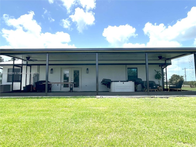 7935 NW 90th Ct, Okeechobee, FL 34972 - back of property with a lawn, french doors, and stucco siding
