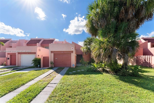 1649 NW 56th Ter Unit 9, Lauderhill, FL 33313 - view of front of property featuring stucco siding, driveway, and an attached garage