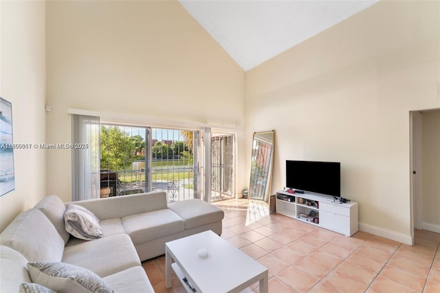 1649 NW 56th Ter Unit 9, Lauderhill, FL 33313 - living area with high vaulted ceiling, light tile patterned flooring, and baseboards