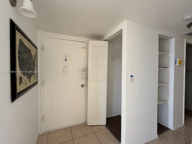 1301 NE Miami Gardens Dr Unit 1025W, Miami, FL 33179 - foyer entrance featuring light tile patterned floors and baseboards