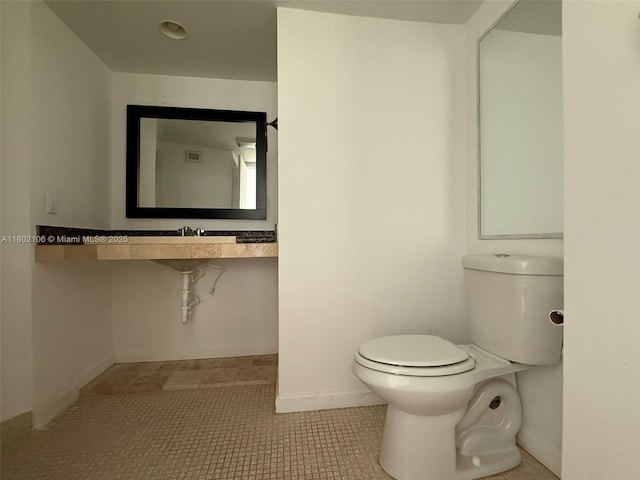 1301 NE Miami Gardens Dr Unit 1025W, Miami, FL 33179 - half bathroom with toilet, baseboards, and tile patterned flooring