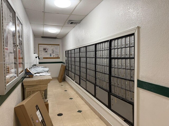 1301 NE Miami Gardens Dr Unit 1025W, Miami, FL 33179 - surrounding community with a textured wall, mail area, and a drop ceiling