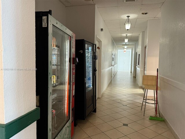 1301 NE Miami Gardens Dr Unit 1025W, Miami, FL 33179 - corridor with light tile patterned floors and a drop ceiling