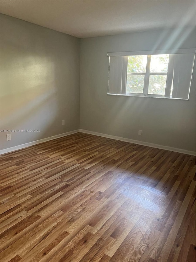 3300 Spanish Moss Ter Unit 210, Lauderhill, FL 33319 - empty room featuring dark wood-type flooring and baseboards