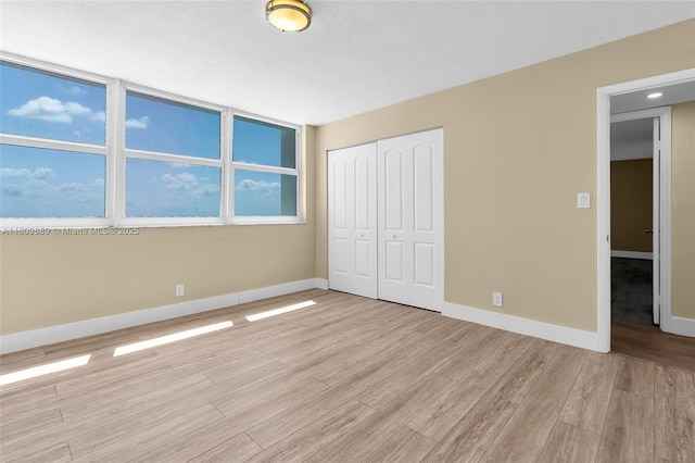 1904 S Ocean Dr Unit 1004, Hallandale Beach, FL 33009 - unfurnished bedroom featuring light wood-style flooring, a closet, and baseboards