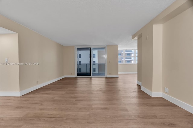 1904 S Ocean Dr Unit 1004, Hallandale Beach, FL 33009 - unfurnished living room featuring wood finished floors and baseboards