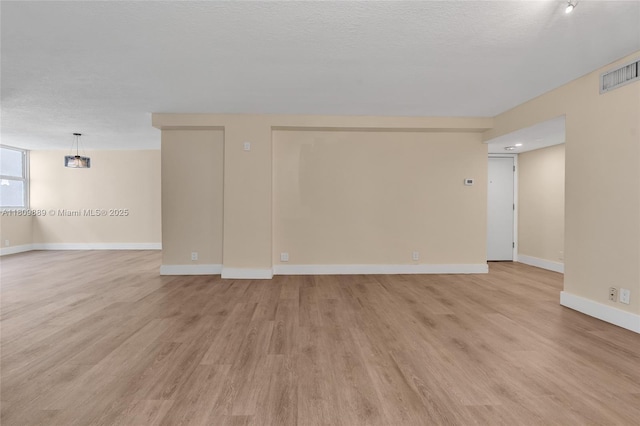 1904 S Ocean Dr Unit 1004, Hallandale Beach, FL 33009 - spare room with light wood-type flooring, baseboards, and a textured ceiling
