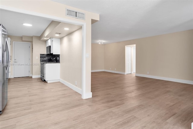 1904 S Ocean Dr Unit 1004, Hallandale Beach, FL 33009 - kitchen with appliances with stainless steel finishes, baseboards, light wood finished floors, and white cabinets