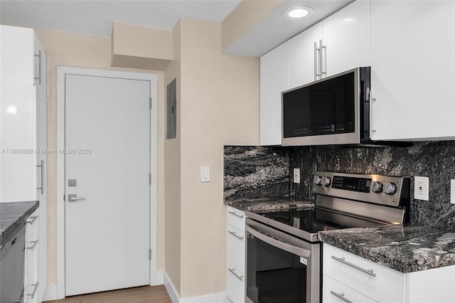 1904 S Ocean Dr Unit 1004, Hallandale Beach, FL 33009 - kitchen featuring appliances with stainless steel finishes, backsplash, white cabinets, and dark stone counters