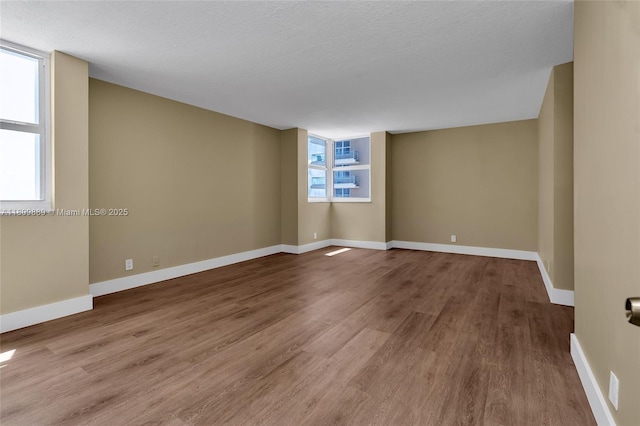 1904 S Ocean Dr Unit 1004, Hallandale Beach, FL 33009 - spare room with wood finished floors, baseboards, and a textured ceiling