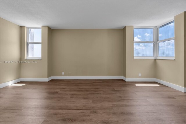 1904 S Ocean Dr Unit 1004, Hallandale Beach, FL 33009 - empty room featuring healthy amount of natural light, baseboards, and wood finished floors