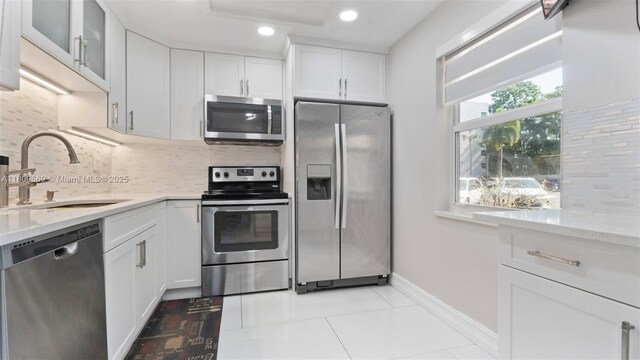 3910 Inverrary Blvd Unit 101-B, Lauderhill, FL 33319 - kitchen featuring appliances with stainless steel finishes, a sink, tasteful backsplash, white cabinetry, and recessed lighting