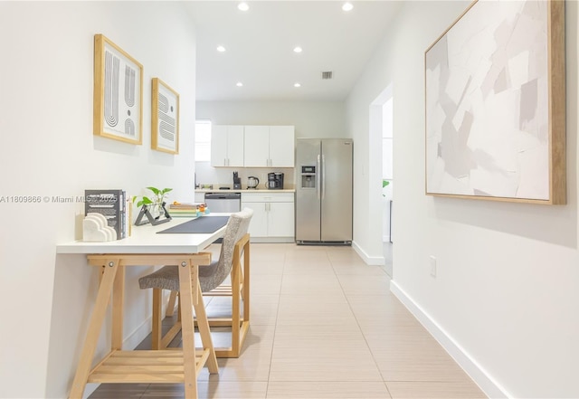 168 NE 47th St, Miami, FL 33137 - kitchen featuring stainless steel refrigerator with ice dispenser, dishwashing machine, recessed lighting, white cabinetry, and light countertops