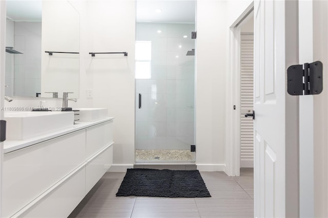 168 NE 47th St, Miami, FL 33137 - bathroom with a stall shower, double vanity, tile patterned flooring, baseboards, and recessed lighting