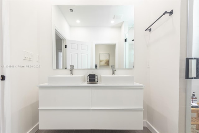 168 NE 47th St, Miami, FL 33137 - full bathroom featuring double vanity and baseboards