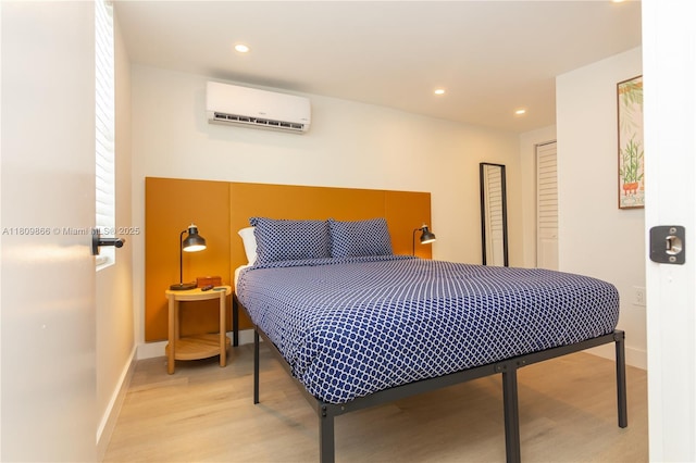 168 NE 47th St, Miami, FL 33137 - bedroom with a wall unit AC, light wood-style flooring, baseboards, and recessed lighting