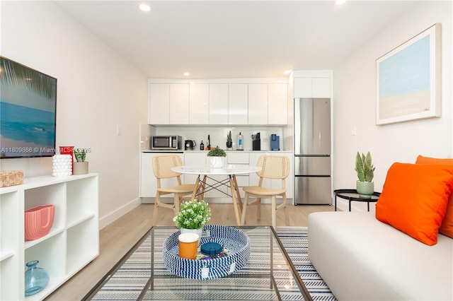 168 NE 47th St, Miami, FL 33137 - living room with light wood-style flooring, recessed lighting, and baseboards