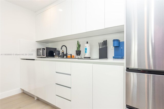 168 NE 47th St, Miami, FL 33137 - kitchen with stainless steel appliances, white cabinets, modern cabinets, and light countertops