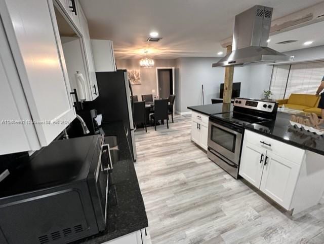 2359 Gabriel Ln, West Palm Beach, FL 33406 - kitchen featuring stainless steel appliances, island range hood, light wood-style flooring, and white cabinetry