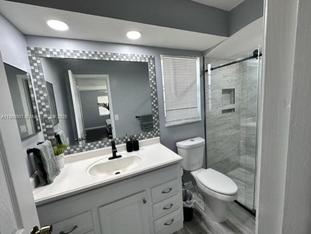 2359 Gabriel Ln, West Palm Beach, FL 33406 - full bath with vanity, toilet, a stall shower, wood finished floors, and recessed lighting