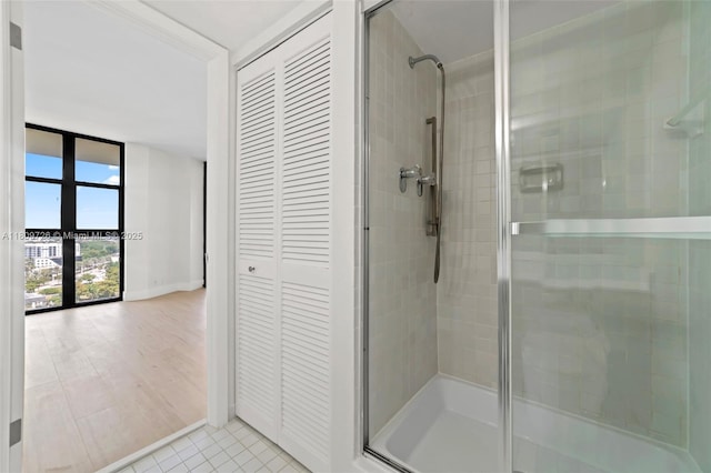 1000 Quayside Ter Unit 1909, Miami, FL 33138 - full bathroom featuring a shower stall, a closet, tile patterned floors, and baseboards