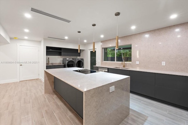 11505 NE 11th Pl, Biscayne Park, FL 33161 - kitchen featuring a sink, washer and dryer, modern cabinets, dark cabinets, and recessed lighting
