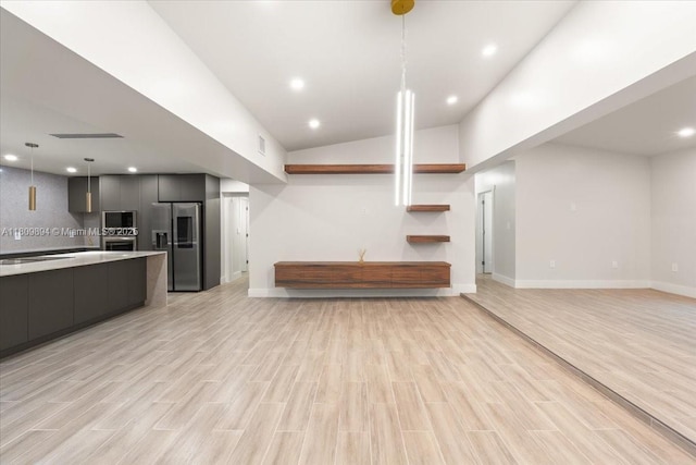 11505 NE 11th Pl, Biscayne Park, FL 33161 - kitchen with modern cabinets, appliances with stainless steel finishes, open floor plan, light countertops, and hanging light fixtures