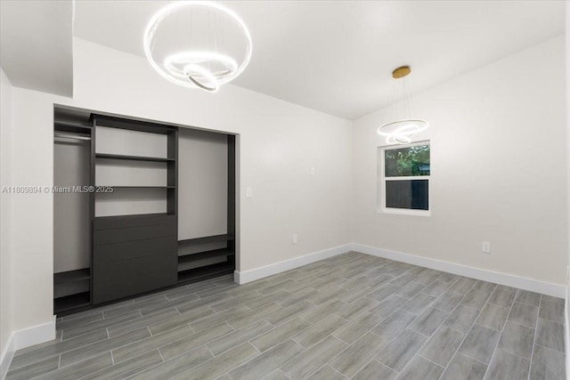 11505 NE 11th Pl, Biscayne Park, FL 33161 - unfurnished bedroom featuring baseboards, a chandelier, light wood-style floors, and a closet
