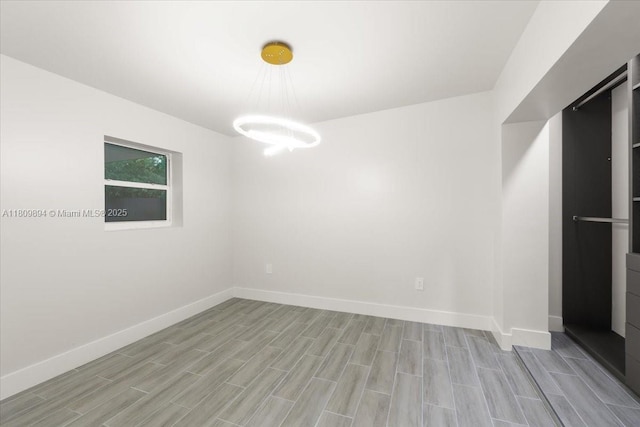 11505 NE 11th Pl, Biscayne Park, FL 33161 - spare room featuring light wood-type flooring and a chandelier