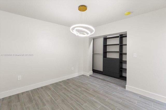 11505 NE 11th Pl, Biscayne Park, FL 33161 - unfurnished room with a chandelier, light wood-type flooring, and a smoke detector