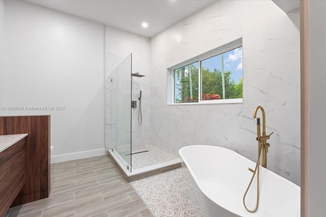 11505 NE 11th Pl, Biscayne Park, FL 33161 - bathroom featuring a freestanding bath, a marble finish shower, vanity, and recessed lighting