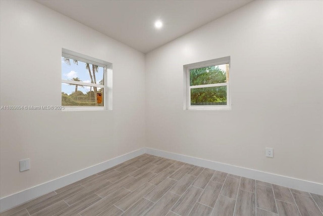 11505 NE 11th Pl, Biscayne Park, FL 33161 - spare room with healthy amount of natural light, baseboards, light wood finished floors, and recessed lighting