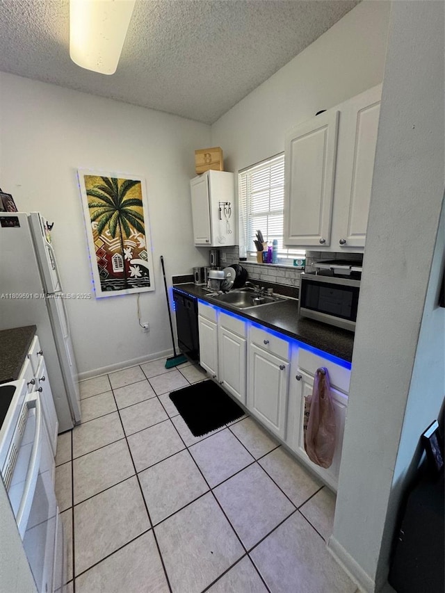 2151 NW 96th Ter Unit 15G, Pembroke Pines, FL 33024 - kitchen featuring a sink, a textured ceiling, white appliances, dark countertops, and white cabinets