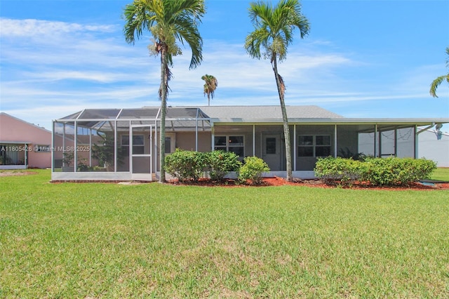 2597 SE 7th Ct, Homestead, FL 33033 - rear view of property with a yard and a sunroom