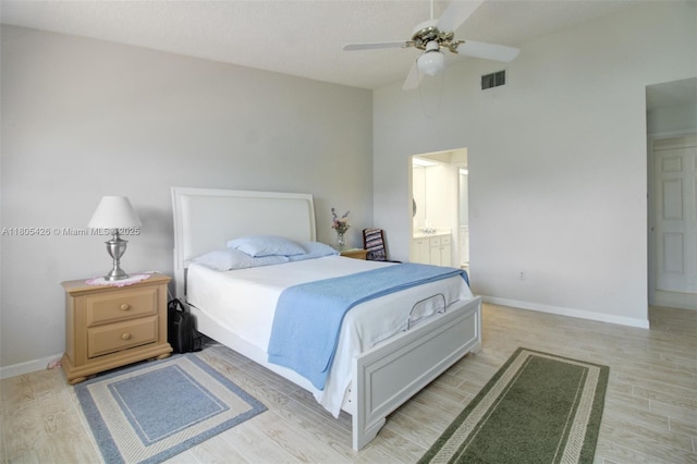 2597 SE 7th Ct, Homestead, FL 33033 - bedroom featuring light wood finished floors, baseboards, high vaulted ceiling, ensuite bathroom, and a ceiling fan