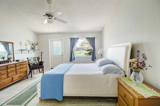 2597 SE 7th Ct, Homestead, FL 33033 - bedroom with a textured ceiling, a ceiling fan, and light wood-type flooring