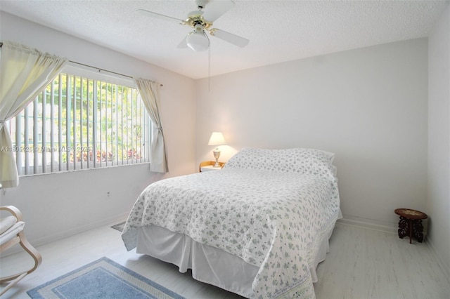 2597 SE 7th Ct, Homestead, FL 33033 - bedroom with a textured ceiling, baseboards, and ceiling fan