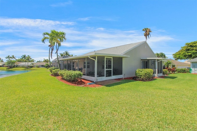 2597 SE 7th Ct, Homestead, FL 33033 - rear view of house with a sunroom, a yard, and a water view