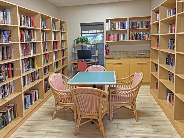 2597 SE 7th Ct, Homestead, FL 33033 - living area featuring bookshelves and wood tiled floors