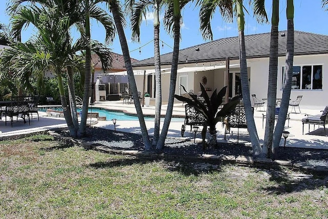 16272 SW 42nd Ter, Miami, FL 33185 - back of property with a patio area, an outdoor pool, and stucco siding